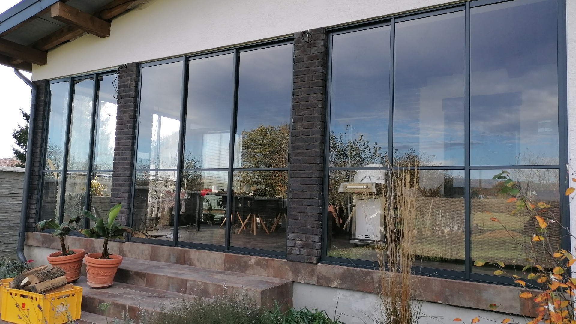 Glazed balcony with brick wall
